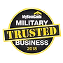Circular badge with “Military Trusted Business 2018” in white and yellow text on black background; “MyBaseGuide” logo at the top.